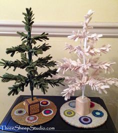 a small christmas tree sitting on top of a table next to a piece of cake