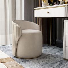 a white chair sitting in front of a mirror on top of a table next to a dresser