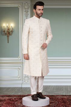 This groom sherwani is expertly crafted with thread embroidery and adorned with sparkling stones, creating a sophisticated and luxurious look. Perfect for weddings, this sherwani exudes elegance and style. Enhance your groom's ensemble with this exquisite piece. Groom Sherwani, Mens Sherwani, Thread Embroidery, Floral White, Thread, Weddings, Embroidery