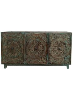 an ornately decorated sideboard with three doors and two drawers, one door open to reveal