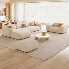 a modern living room with white furniture and wood flooring