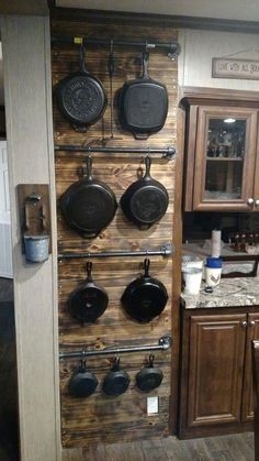 a kitchen with pots and pans hanging on the wall