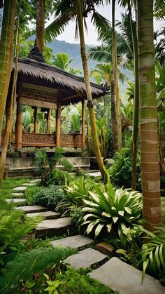 a gazebo surrounded by lush green trees and plants in a tropical garden with stone steps leading up to it