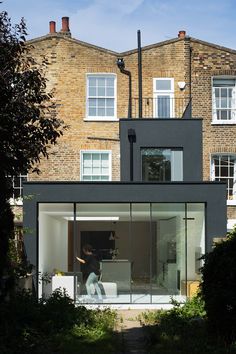 a person standing in front of a building with glass doors on the outside and inside