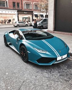 a blue sports car parked on the street