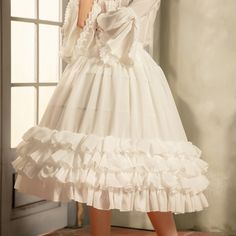 Elevate your Lolita or Kawaii outfit with our 75cm white/beige tiered hemline birdcage chiffon fish-bone petticoat. This petticoat features a beautiful tiered hemline and is made of delicate chiffon material, creating a birdcage silhouette that adds volume and shape to your skirt or dress. The fish-bone design ensures that the petticoat maintains its structure, giving your outfit a polished and elegant look.  Please note that this product includes only one petticoat.  Garment Size   	 		 			Size 			Free Size 		 		 			Full Length 			75 		 		 			Waist 			58-95 White Tiered Skirt Dress With Attached Cancan, Summer Crinoline Petticoat With Ruffles, White Ruffled Feminine Skirt, White Fairy Kei Skirt With Ruffles, Feminine White Ruffled Skirt, White Feminine Skirt With Ruffles, Feminine White Skirt With Ruffle Hem, Fairy Kei Style Ruffled Skirt For Summer, Tiered Ruffled Petticoat