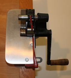 a close up of a piece of metal on a table with a tool attached to it