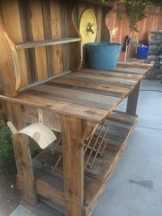 an outdoor table made out of pallets and wooden planks with a bucket on top