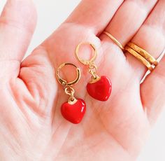 Red heart drop earrings. Small red enamel romantic dainty love heart drop earrings. They will make a perfect gift for young and young-at-heart women. Make a set with one of my red heart necklaces!: https://www.etsy.com/listing/777649361/ ♥ Details: You will get 1 Pair Color: red, gold Length: Pendant size:  More heart jewelry: https://www.etsy.com/shop/myfaunaflora?ref=seller-platform-mcnav&section_id=20929416 Visit my shop to see the full statement jewelry collection: https://www.etsy.com/shop/myfaunaflora Returns and exchange policy: https://www.etsy.com/shop/myfaunaflora#policies Shipping & Packaging: The jewelry will be packed with the most caution and care and sent to you in a GIFT WRAP in a padded envelope. Items are shipped within 3-5 business days of being paid. All orders are ship Red Heart Pendant Earrings, Heart Charm Enamel Earrings, Heart-shaped Enamel Earrings With Charm, Heart Detail Double Heart Earrings For Gift, Elegant Enamel Heart Earrings For Gift, Heart-shaped Earrings With Heart Detail As Gift, Elegant Heart Enamel Earrings For Gift, Gift Double Heart Detail Earrings, Valentine's Day Heart Charm Enamel Earrings