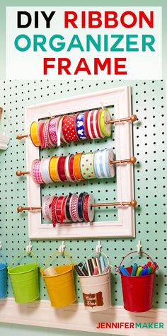 the diy ribbon organizer frame is organized with colorful ribbons and buckets on it