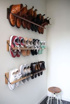 several pairs of shoes are hanging on the wall