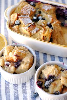 blueberry cobbler in a casserole dish with lemon wedges on the side