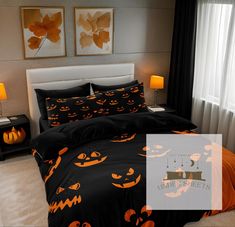 a bed with black and orange pumpkins on it