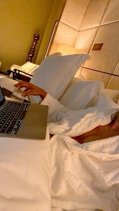 a laptop computer sitting on top of a bed