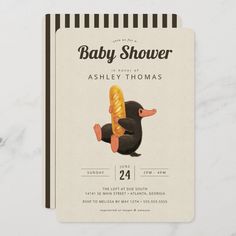 a baby shower card with an image of a duck holding a piece of bread in it's mouth