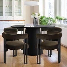 a dining room table with four chairs around it