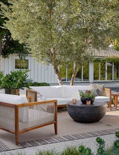 an outdoor living area with couches and tables