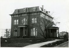 an old photo of a large house with many windows