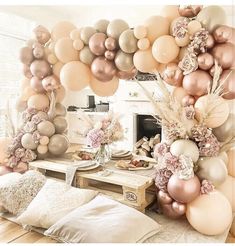 a living room filled with lots of balloons and flowers on top of a wooden floor