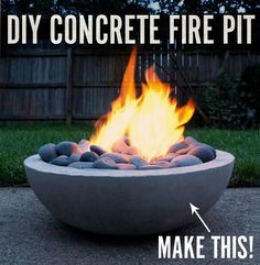 a concrete fire pit with rocks in it