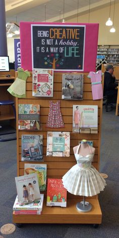 a display case filled with lots of books and paper crafts on top of a wooden table