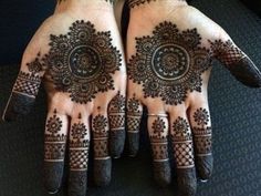 two hands with henna designs on them