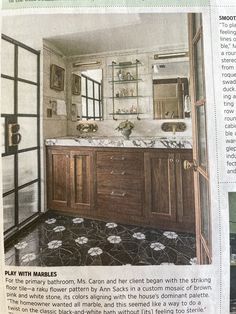 an article in the paper shows a bathroom with marble counter tops and wooden cabinets, along with black and white patterned flooring