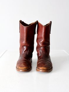 "This is a pair of vintage Red Wing work boots.  Beautifully aged, russet brown leather shapes the boots with the classic pull-on shape.  CONDITION In good condition with wear consistent with age and use.  Natural wear to the heel.  General scuffs and wear to the leather.  APPROXIMATE FIT:  Women's 8.5  / Men's 7 MEASUREMENTS Wall to Toe Length:  11\"  ..   27.9 cm OutSole Width: 3.875\"  ...  9.8 cm Height:  11.25\"  ..  28.6 cm Circumference at Top:  13.75\"  ..  34.9 cm Heel:  1.25\"  ..  3.2 cm 81922" Rustic Brown Work Boots With Goodyear Welt, Vintage Leather Chelsea Boots With Snip Toe, Rugged Vintage Brown Boots With Goodyear Welt, Brown Vintage Boots With Goodyear Welt Construction, Vintage Vegetable-tanned Leather Boots, Vintage Moto Boots With Round Toe For Western Events, Brown Vintage Moto Boots With Goodyear Welt, Vintage Moto Boots With Round Toe For Western-themed Events, Vintage Leather Moto Boots For Western-themed Events