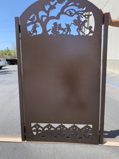 a large metal sign sitting in the middle of a parking lot