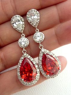 This classy earring features a LARGE  red (with a touch of orange) peardrop cubic zirconia (20 X 15 mm  clear back) with multi small zirconias around it, dangle from a round cubic zirconia connector,  with a platinum gold plated peardrop cubic zirconia post earring..Size: 4.5  x 1.5 cm or about 1.8 inches long.Matching necklace is also available:Yellow gold version is also available:Listing: http://www.etsy.com/listing/164900669/wedding-bridal-earring-large-halo-redOther colour is also available Bridal Earring, Classy Earrings, Diamond Earrings Design, Clear Back, Stone Jewellery, Crystal Fashion, Ear Rings, Emerald Jewelry, Large Earrings