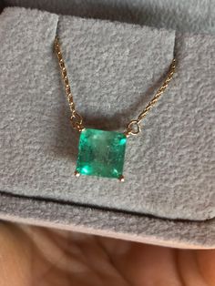 Square Cut Colombian Emerald Solitaire Pendant Drop Necklace in 14K Yellow Gold. This necklace features a medium green natural Colombian emerald, clarity: SI, Weight 1.68 Carat, Square Shaped 7.0mm x 7.0mm prong-style setting. Wheat Chain 14K Yellow Gold 16.5" total pendant necklace weight 2.55g Emeralds typically contain inclusions that are visible to the unaided eye. Because of this, trade members and some consumers understand and accept the presence of inclusions in emeralds. Eye-clean emeralds are especially valuable because they’re so rare. Emerald inclusions are often described as looking mossy or garden-like. They’re sometimes called "jardin,” which is French for garden. Formal Hallmarked Emerald Necklace, Formal Emerald Necklaces With Diamond Cut, Elegant Hallmarked Green Emerald Necklace, Luxury Green Emerald Necklace For Anniversary, Luxury Green Emerald Necklaces, Green Fine Jewelry Necklace For Formal Occasions, Hallmarked Round Emerald Necklace, Formal Emerald Necklace With Square Pendant, Luxury 14k Gold Emerald Necklace For May Birthstone