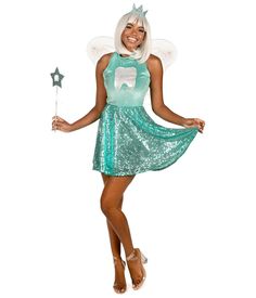 a woman dressed as tooth fairy holding a wand and wearing a green sequin dress