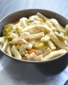 a bowl filled with pasta and vegetables on top of a table