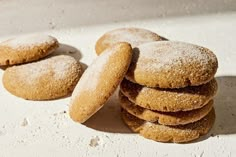 a stack of sugar cookies sitting on top of a white counter next to each other