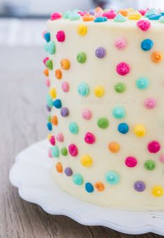 a white cake with multi colored sprinkles on it