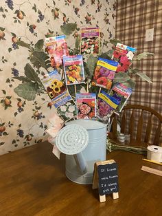 there is a bucket full of flowers and cards on the table next to a chalkboard