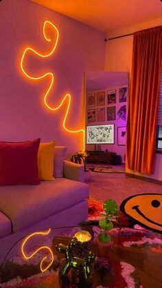 a living room filled with furniture and colorful lights on the wall above it's coffee table