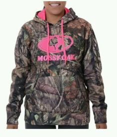 a woman wearing a mossy oak hoodie with pink lettering on the chest and bottom