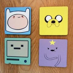 four square coasters with cartoon characters on them