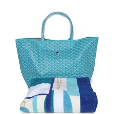 This Limited Edition St. Louis GM tote bag with a large Balise beach towel is in turquoise blue Goyardine coated canvas and chevroches calfskin leather with palladium hardware, contrast stitching, and comes matching detachable button closure wallet.The interior of the tote bag is lined with white canvas.The beach towel included is made of terry cloth and is multicolored with printed floating buoys.Origin: FranceCondition: New and never worn (plastic on handles)Accompanied by: Dustbag, felt, retail tag, removable pouch, towel dustbagMeasurements: tote bag: 15.7" x 13" x 7.8"; beach towel: 36" x 60" Luxury Turquoise Travel Bags, Luxury Blue Shoulder Bag For Summer, Blue Summer Bags For Poolside, Blue Beach Bag For Poolside Use, Blue Beach Bag For Poolside, Blue Beach Bag For Poolside During Beach Season, Blue Summer Poolside Bags, Blue Poolside Beach Bag For Beach Season, Blue Tote Bag For Poolside