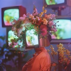 a person with flowers on their head watching tv