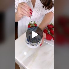 a woman is cutting strawberries with a knife