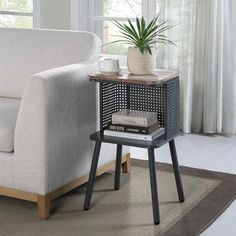 a living room with a couch, chair and end table in front of a window