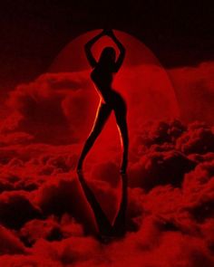 a woman standing on clouds in front of a red moon