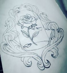 a rose tattoo design on the back of a woman's leg with swirls