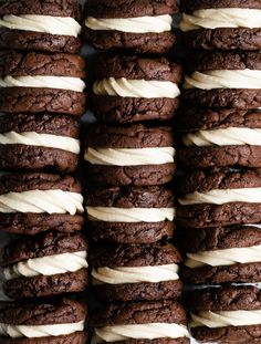 chocolate cookies with white frosting stacked on top of each other