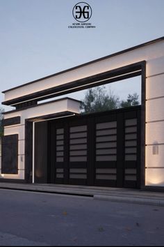 an image of a modern house with black and white architecture on the front entrance to it