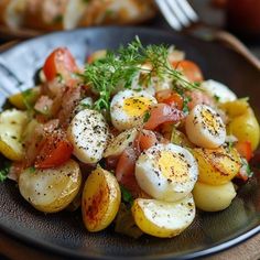 a black plate topped with potatoes and eggs