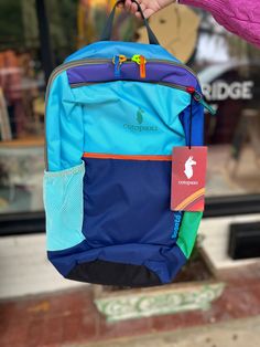 From Cotopaxi:"Bike rides to class, hikes to your favorite lake, or bus rides to wild corners of the world—wherever you’re headed and however you’re going, the Bogota 20L Backpack is here to keep your essentials in check. The 15” laptop sleeve keeps your tech safe while the breathable back panel and shoulder straps keep you cool." After selecting a color type, the second image will be of the back of the item chosen. For more photos you may text or call us at (229) 421-9386. Internal laptop sleev Blue Nylon Backpack For Adventure, Blue Adventure Backpack Standard Shape, Blue Adventure Backpack, Blue Waterproof Backpack For Hiking, Multicolor Backpack For Outdoor Activities, Blue Functional Adventure Backpack, Blue Outdoor Backpack With Water Bottle Pocket, Blue Backpack With Water Bottle Pocket For Outdoor Activities, Blue Backpack With Water Bottle Pocket For Outdoor