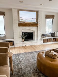 a living room filled with furniture and a fire place in front of a tv mounted on the wall